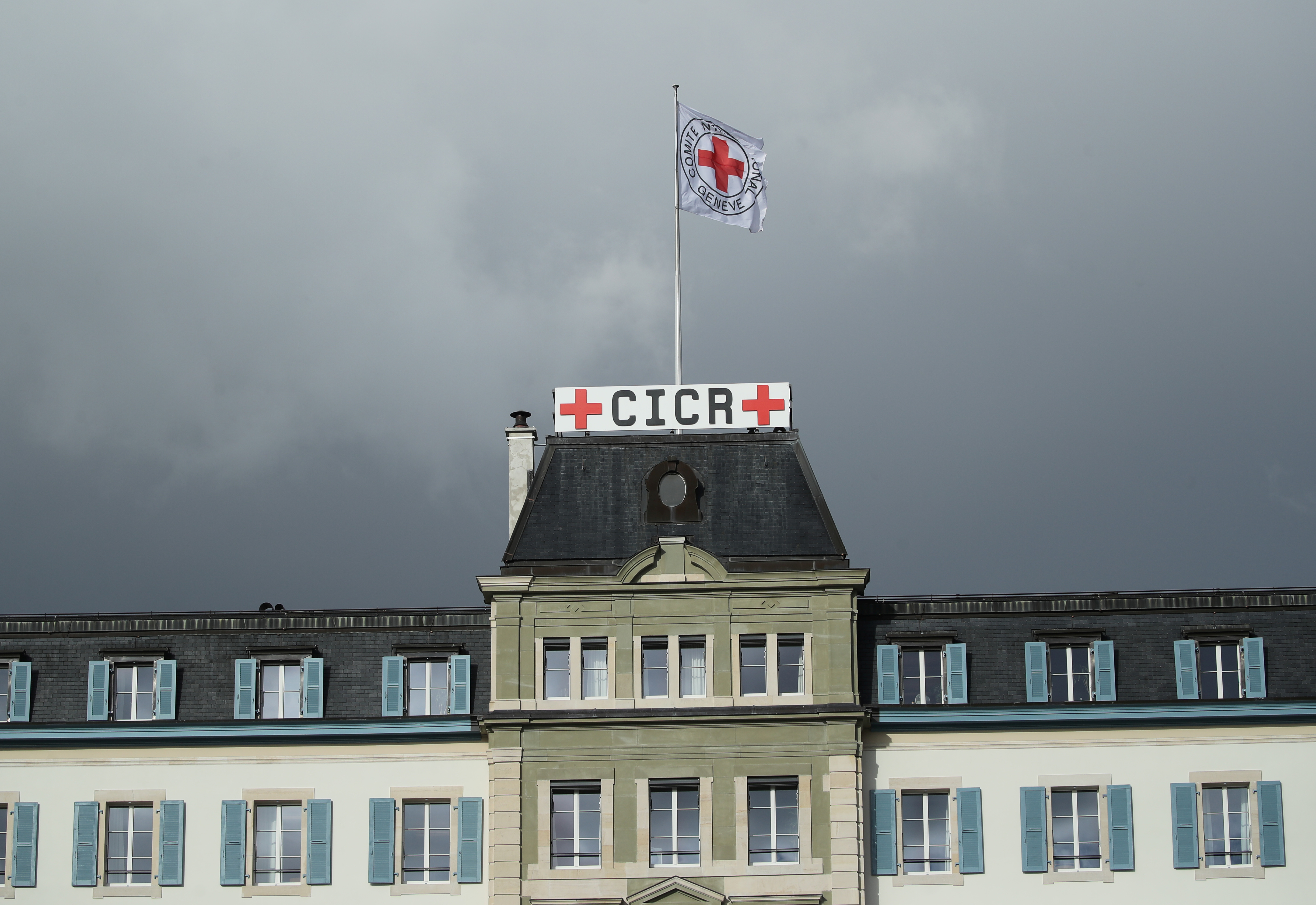 A flag on the International Committee of the Red Cross (ICRC) headquarters in Geneva, Switzerland on December 4, 2018. The Geneva Conventions tasked the committee with protecting victims of armed conflicts and monitoring countries' compliance with the conventions. Source: Denis Balibouse/Reuters.