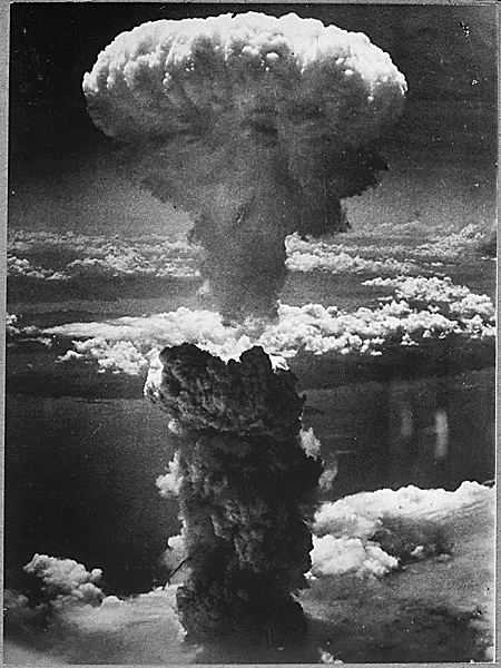 A dense column of smoke rises more than 60,000 feet into the air over the Japanese port of Nagasaki, the result of an atomic bomb, the second ever used in warfare, dropped on the industrial center on August 9, 1945. Source: U.S. National Archives.