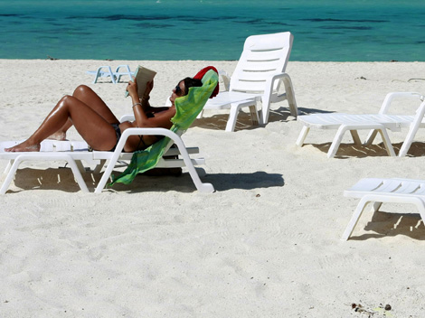 A tourist reads a book in Turatao Marine National Park off the Andaman Sea in southern Thailand’s Satun province on December 22, 2008.