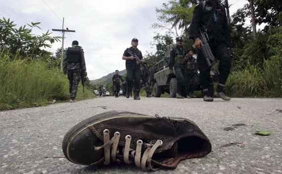 Thai security personnel inspect the site of an attack on an army patrol in Yala province