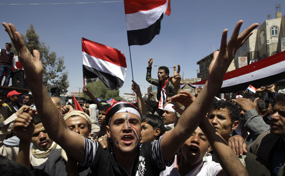 Anti-government protesters shout slogans during a protest demanding the ouster of Yemen’s President Ali Abdullah Saleh outside Sanaa