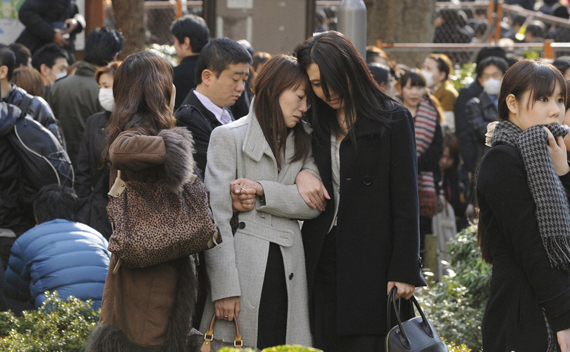 Evacuees stand around Shinjuku Central Park in Tokyo Japan March 11, 2011. A massive 8.9 magnitude quake hit northeast Japan on Friday, causing many injuries, fires and a ten-metre (33-ft) tsunami along parts of the country’s coastline.