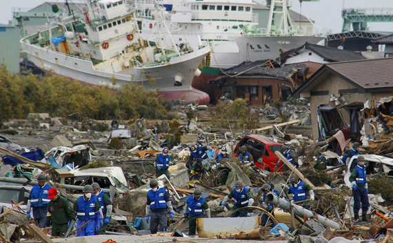Japan Self-Defense Forces officers search for victims in Higashimatsushima City, Miyagi Prefecture in northern Japan, after an earthquake and tsunami struck the area, March 14, 2011.