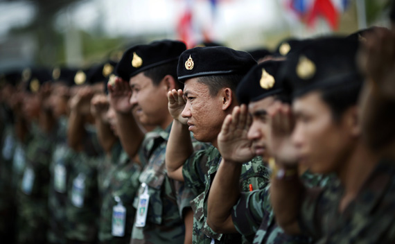 Thai soldiers salute as a coffin of their comrade killed in a recent car bombing is flown home from the troubled Yala province in southern Thailand March 2, 2011.