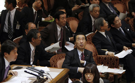 Japan’s Prime Minister Naoto Kan reacts he he feels an earthquake in the upper house of parliament in Tokyo on March 11, 2011.