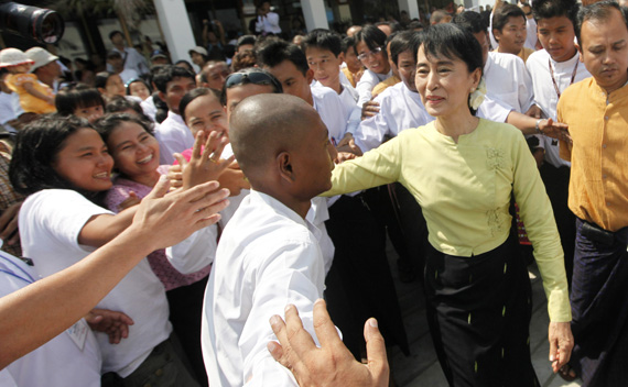 Myanmar’s pro-democracy leader Aung San Suu Kyi shakes hand with people in Yangon