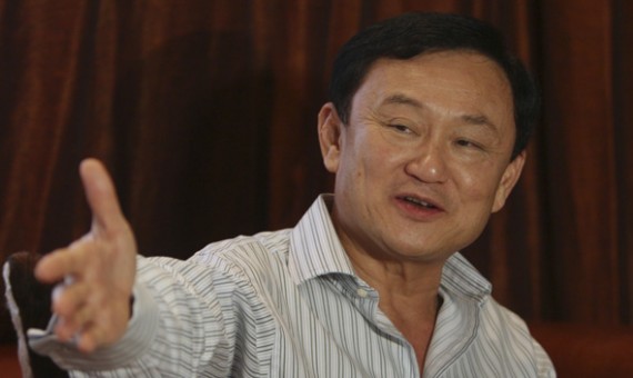 Former Thai Prime Minister Thaksin Shinawatra gestures during a meeting near his home in Dubai, after voting in general elections ended in Bangkok July 3, 2011.