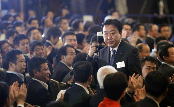 Japan’s Finance Minister Yoshihiko Noda stands up as he is chosen as the party’s new leader while the party lawmakers clap their hands during Japan’s ruling Democratic Party of Japan leadership vote in Tokyo on August 29, 2011.