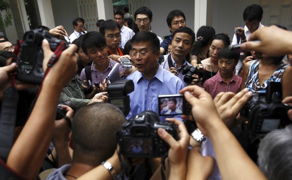 Ambassador Gary Locke is surrounded by local Chinese media outside his residence in Beijing on August 14, 2011.