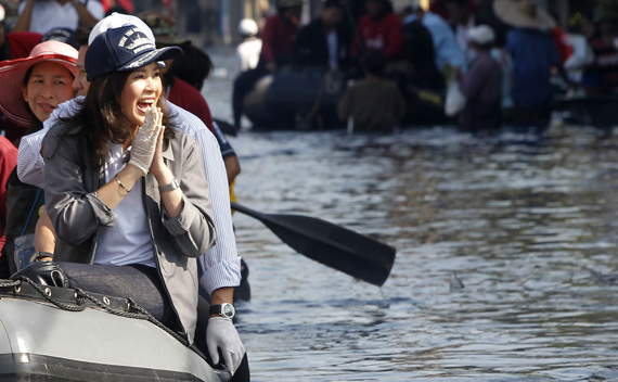 Thailand’s Prime Minister Yingluck Shinawatra gestures to residents during her visit to a flooded area at Don Muang district in Bangkok.