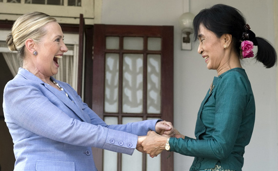 Pro-democracy leader Aung San Suu Kyi (R) and U.S. Secretary of State Hillary Clinton hold hands as they speak after meeting at Suu Kyi’s residence in Yangon December 2, 2011.