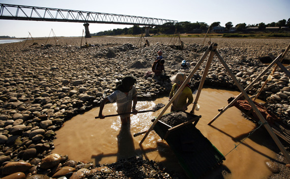 Villagers pan for gold from the Irrawaddy river near the town of Myitkyina in northern Myanmar. Myitkyina has been an important trading town between China and Myanmar since ancient times.
