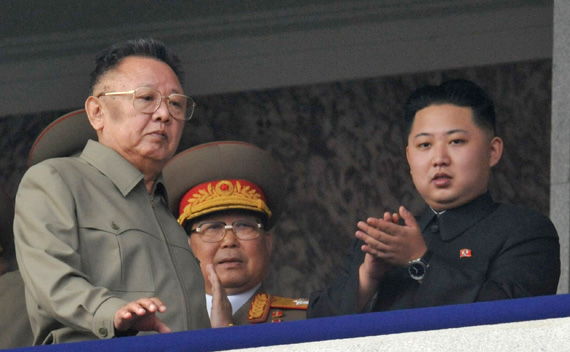 North Korean leader Kim Jong-il (L) walks in front of his youngest son Kim Jong-un (R) as they watch a parade to commemorate the 65th anniversary of the founding of the Workers’ Party of Korea in Pyongyang October 10, 2010