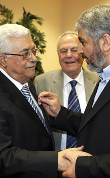 Hamas leader Khaled Meshaal (R) talks with President Mahmoud Abbas (L) during their meeting in Cairo May 4, 2011.