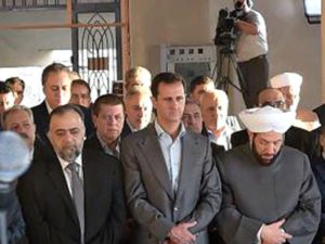 Syria’s President Bashar al-Assad prays during the first day of Eid al-Adha at a mosque in the Damascus suburb of Daraya, Syria in this handout picture provided by SANA on September 12, 2016. (SANA/Reuters).