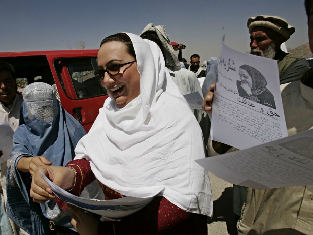 Shukria Barakzai, a member of parliament, hands out leaflets during her August 2005 election campaign in Kabul, Afghanistan. Barakzai later survived a suicide bombing attack in December 2014 (Courtesy Zohra Bensemra/Reuters).