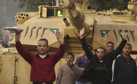 Pro-Mubarak supporters surrender to opposition demonstrators during rioting near Tahrir Square in Cairo.
