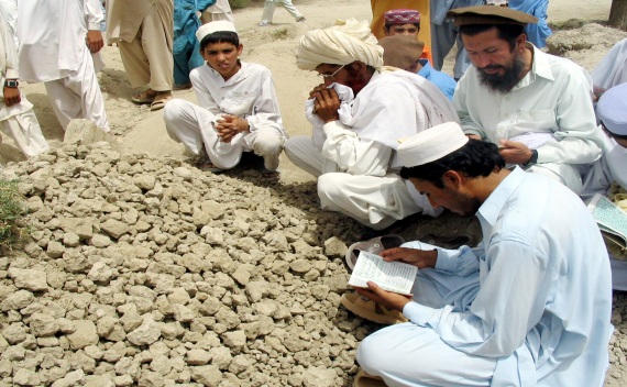 Tribesmen pray at grave of Hayatullah Khan during his funural near Mir Ali in the North Waziristan region on the Afghan border on June 17, 2006 (Faisal Mahmood/Courtesy Reuters).