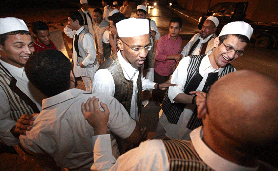 Members of the Libyan Islamic Fighting Group smile when they meet their relatives upon their release from Abu Salim prison near Tripoli August 31, 2010. Libya freed 37 prisoners late on Tuesday, including at least one former detainee at the U.S. military prison at Guantanamo Bay, who had been jailed for links to radical Islamist groups but have since renounced violence. REUTERS/Ismail Zitouny 