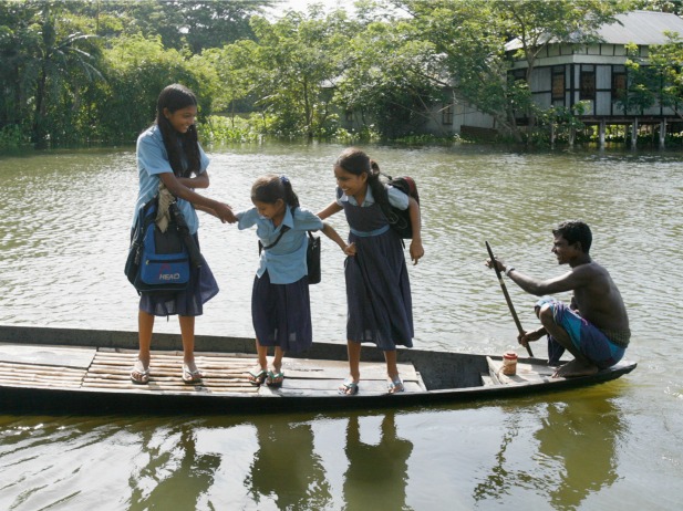 Girls are transported to school by boat in Srinagar, Bangladesh (Courtesy Reuters/Rafiqur Rahman).