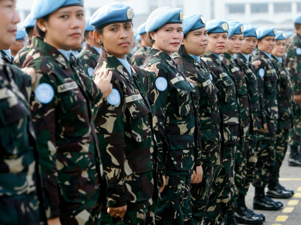 Female members of a Philippine peacekeeping force bound for Liberia stand at attention during a send-off ceremony at the military headquarters in Manila, January 2009 (Romeo Ranoco/Reuters).