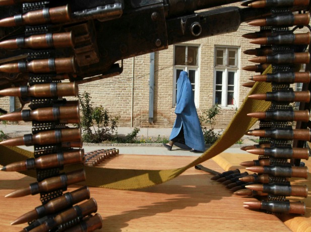 An Afghan woman walks inside a police compound in Herat province, Afghanistan, March 2013 (Courtesy Reuters/Mohmmad Shoib).