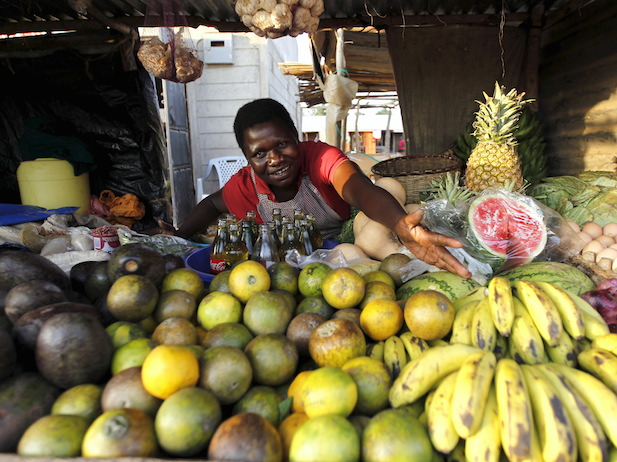 Imelda Akinyi, 25, arranges fruits at her stall in the trading centre of Kogelo, west of Kenya’s capital Nairobi, July 14, 2015. Reuters/Thomas Mukoya
