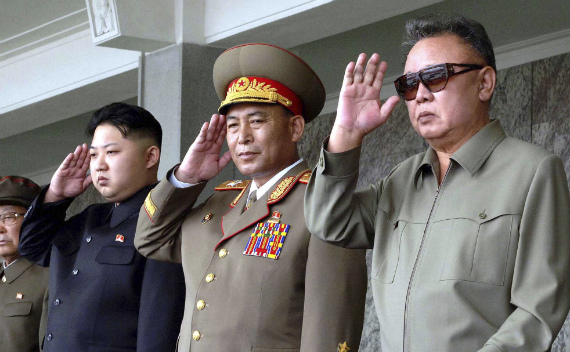 Kim Jong-il and Kim Jong-un salute during a military parade (courtesy Reuters/KCNA)
