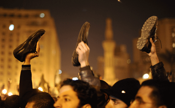 Anti-government protesters in Cairo’s Tahrir Square wave shoes in dismay as President Hosni Mubarak speaks to the nation February 10, 2011. Protesters also chanted,