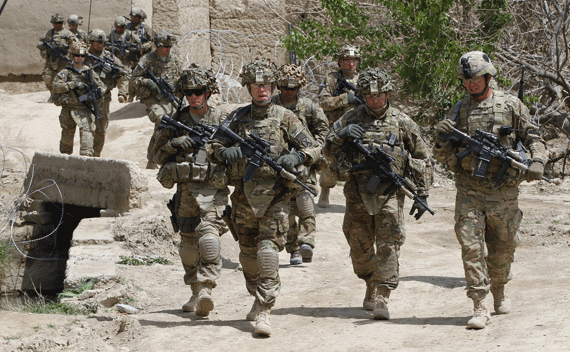 American soldiers walk through a former Taliban-held village north of Kandahar on April 8, 2011.