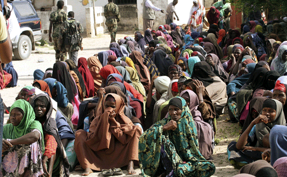 Internally displaced women wait to receive food aid from Saudi Arabia in Badbaado settlement camp in Somalia’s capital Mogadishu, August 17, 2011. Somalia called for the creation of a new force to protect food aid convoys and camps in the famine-hit country, and declared a state of emergency in parts of Mogadishu. REUTERS/Omar Faruk