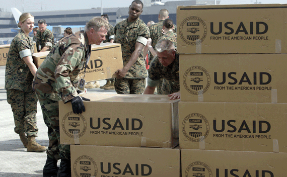 Photographer: REUTERS/Romeo Ranoco American soldiers carry relief supplies for families affected by Typhoon Durian from a cargo plane after its arrival at the Manila International airport December 7, 2006. Americans, through the U.S. Agency for International Development (USAID), provided disaster relief and assistance to the Philippines after it was severely hurt by Typhoon Durian that killed 570 people and destroyed nearly 250,000 houses. REUTERS/Romeo Ranoco (PHILIPPINES)