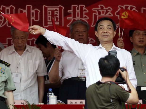 Chongqing Municipality Communist Party Secretary Bo Xilai waves a Chinese national flag during the opening ceremony of a revolutionary song singing concert at Chongqing Olympic Sports Centre in Chongqing municipality on June 29, 2011. More than 70,000 people attended the ceremony to celebrate the 90th anniversary of the founding of the Communist Party of China (CPC) on July 1. 