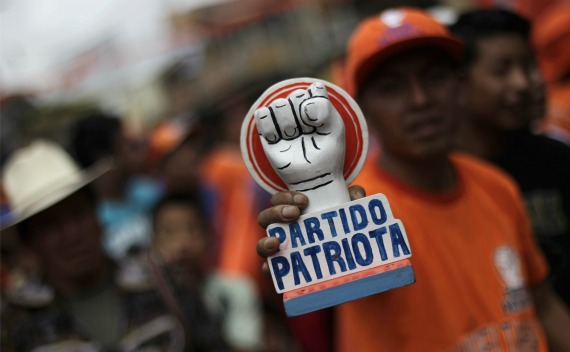 A man holds a symbol of the Patriot Party during a political rally in Solola (Jorge Lopez/Courtesy Reuters).