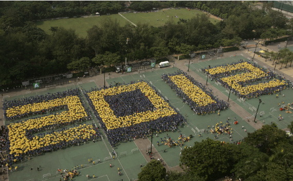 Pro-democracy protesters in Hong Kong use umbrellas to write