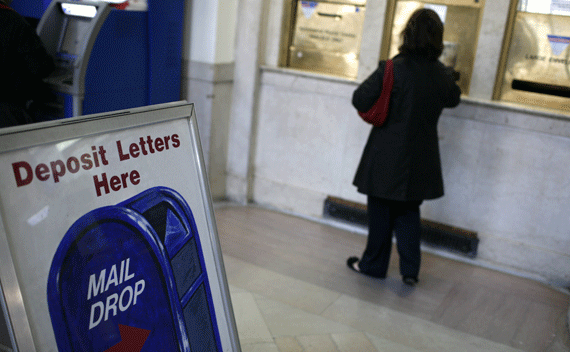 A woman mails envelopes at the James A Farley Post U.S. office in New York on April 15, 2010. (Mike Segar/courtesy Reuters)