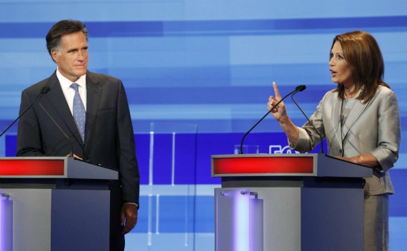 U.S. Republican presidential candidate Michele Bachmann gestures beside Mitt Romney during the Republican presidential debate in Ames (Courtesy Reuters).