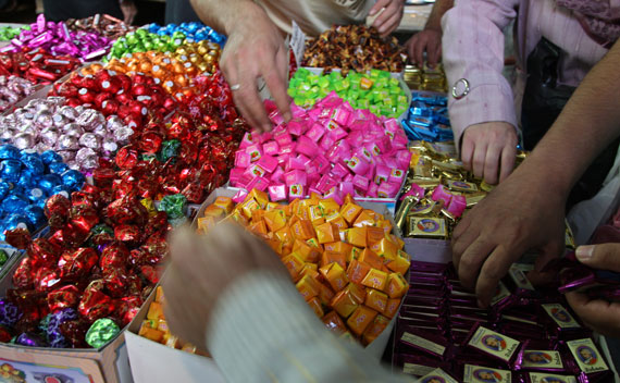 People buy sweets at Souk al-Hamidieh in Damascus’ old downtown (Khaled Al Hariri/Courtesy Reuters)