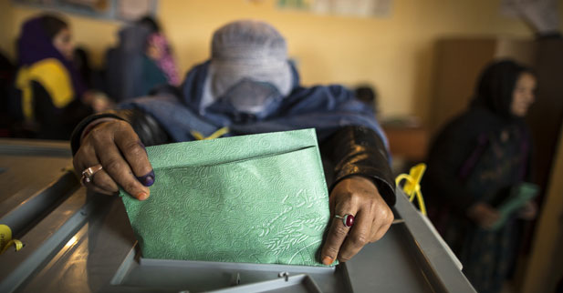 An Afghan woman casts her ballot at a polling station in Mazar-i-sharif