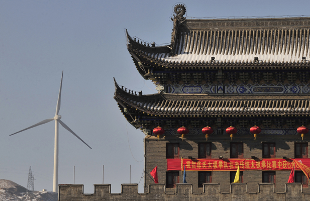 A wind turbine is seen near a gate of the ancient city of Wushu in Diaobingshan.