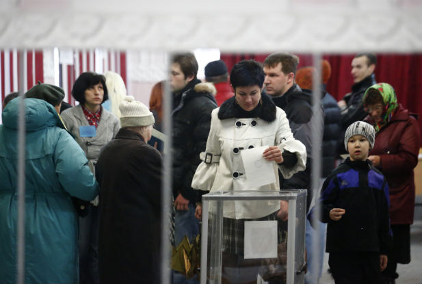 A woman casts her ballot at a polling station in Simferopol on March 16, 2014