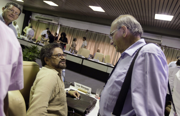 Revolutionary Armed Forces of Colombia (FARC) lead negotiator Ivan Marquez (C) talks to Colombia’s lead government negotiator Humberto de la Calle (R) as FARC negotiator Pablo Catatumbo listens during a meeting in Havana August 21, 2014.
