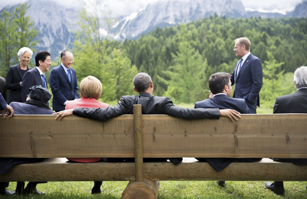 German Chancellor Angela Merkel sits with U.S. President Barack Obama on a bench outside the Elmau castle in Kruen near Garmisch-Partenkirchen, Germany, June 8, 2015. Leaders of the Group of Seven (G7) industrial nations vowed at a summit in the Bavarian Alps on Sunday to keep sanctions against Russia in place until President Vladimir Putin and Moscow-backed separatists fully implement the terms of a peace deal for Ukraine.