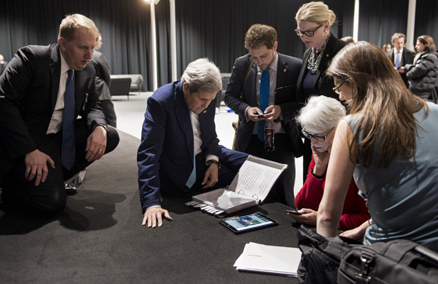 U.S. Secretary of State John Kerry (2nd L), U.S. Under Secretary for Political Affairs Wendy Sherman (2nd R) and staff watch a tablet in Lausanne as U.S. President Barack Obama makes a state address on the status of the Iran nuclear program talks, April 2, 2015.