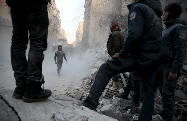 Residents look for survivors in a site hit by what activists said were airstrikes carried out by the Russian air force in the town of Douma, eastern Ghouta in Damascus, Syria January 10, 2016.