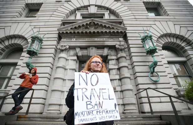 A protester stands outside the 9th U.S. Circuit Court of Appeals courthouse in San Francisco.