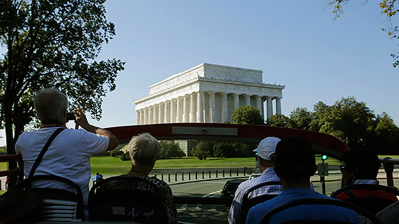 Tourists view the closed Lincoln Memorial in Washington atop a Big Bus double-decker tour bus, during the second day of a U.S. government shutdown, October 2, 2013