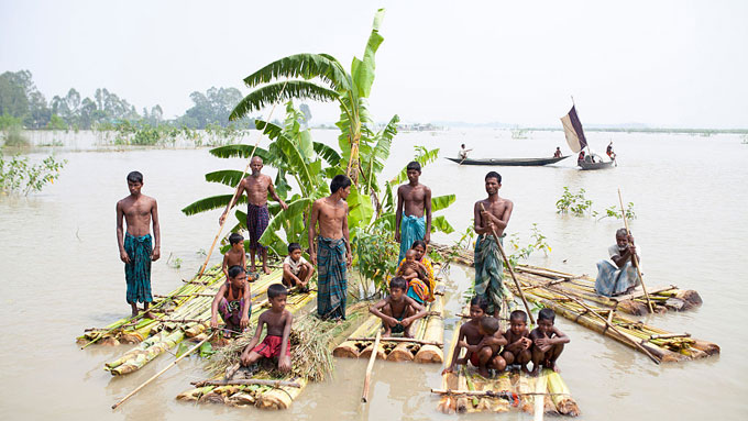 People waiting for food from flood relief on September 7, 2015, in Kurigram District, Bangladesh, after devastating floods and landslides triggered by heavy rains.