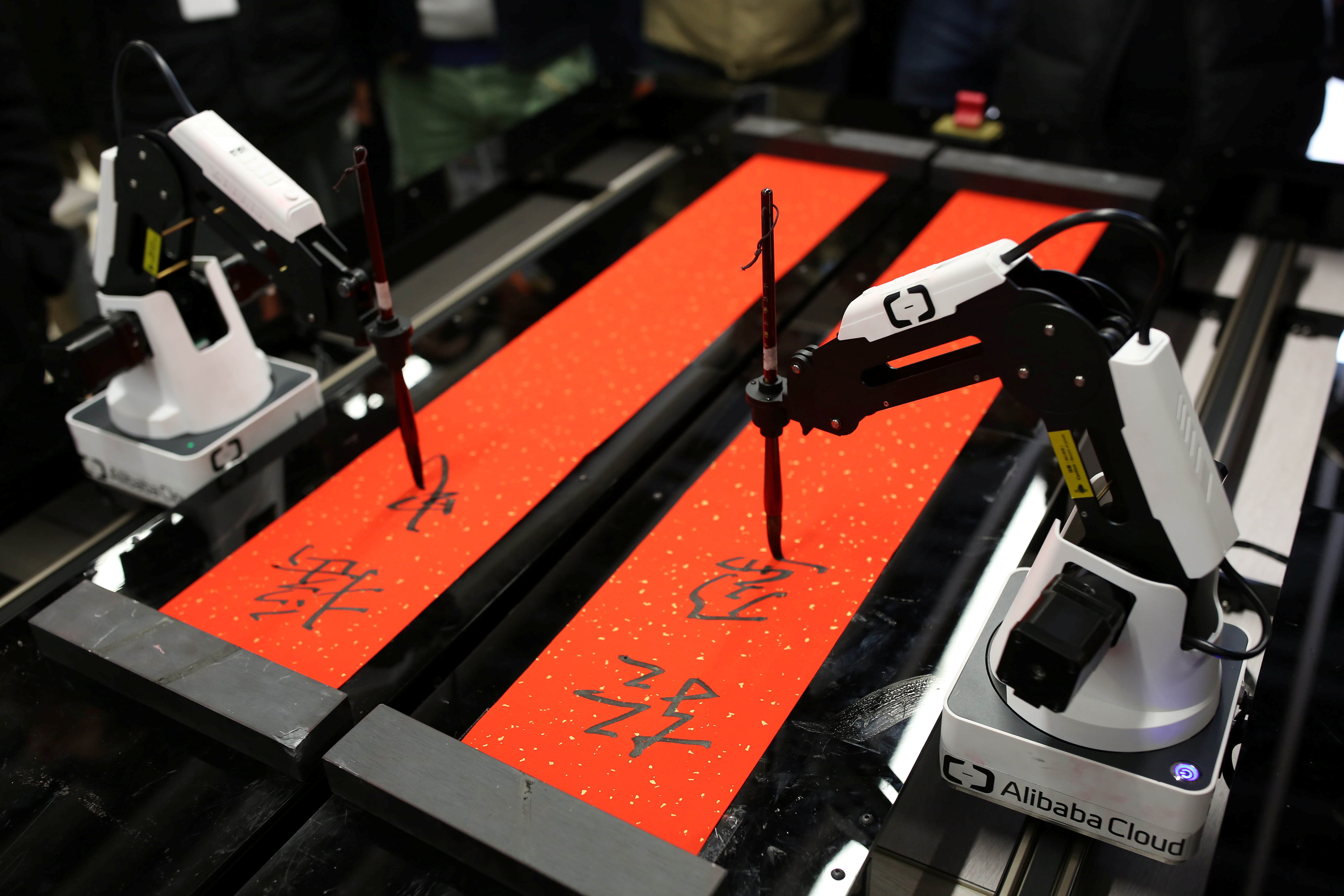 Robots write calligraphy couplets for employees ahead of the upcoming Spring Festival, at Alibaba's headquarters in Hangzhou, China, on January 16, 2017.