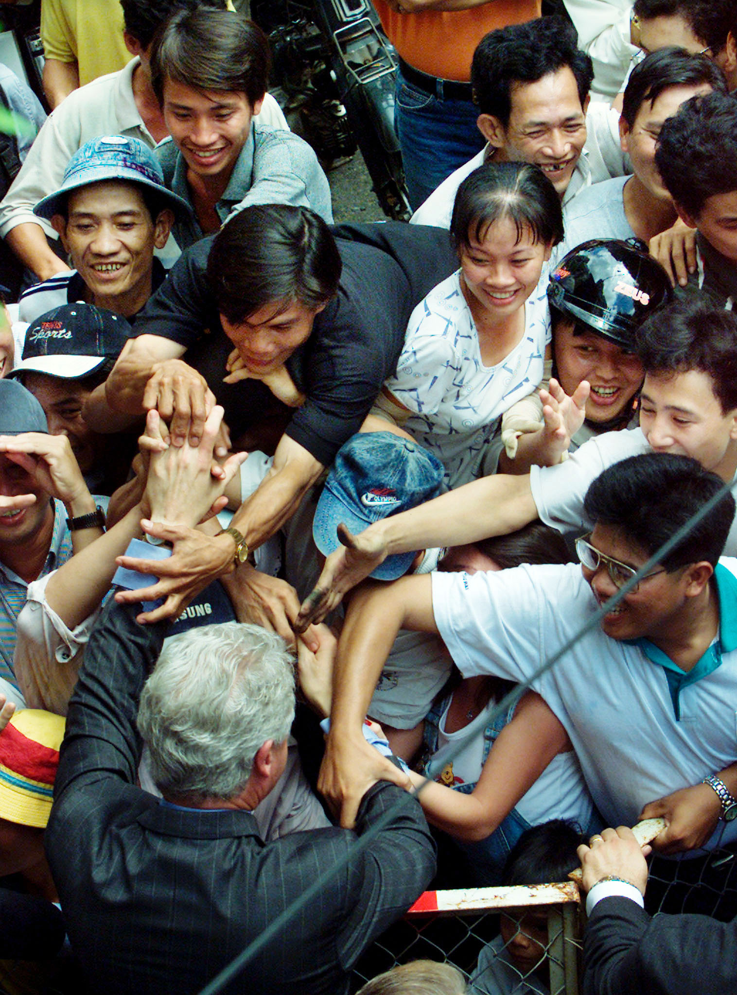 U.S. President Bill Clinton greets people on the streets of Ho Chi Minh City on his three-day visit to Vietnam in November 2000.